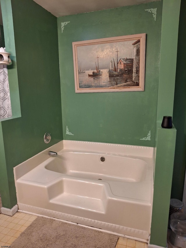 bathroom featuring tile patterned flooring and a tub to relax in