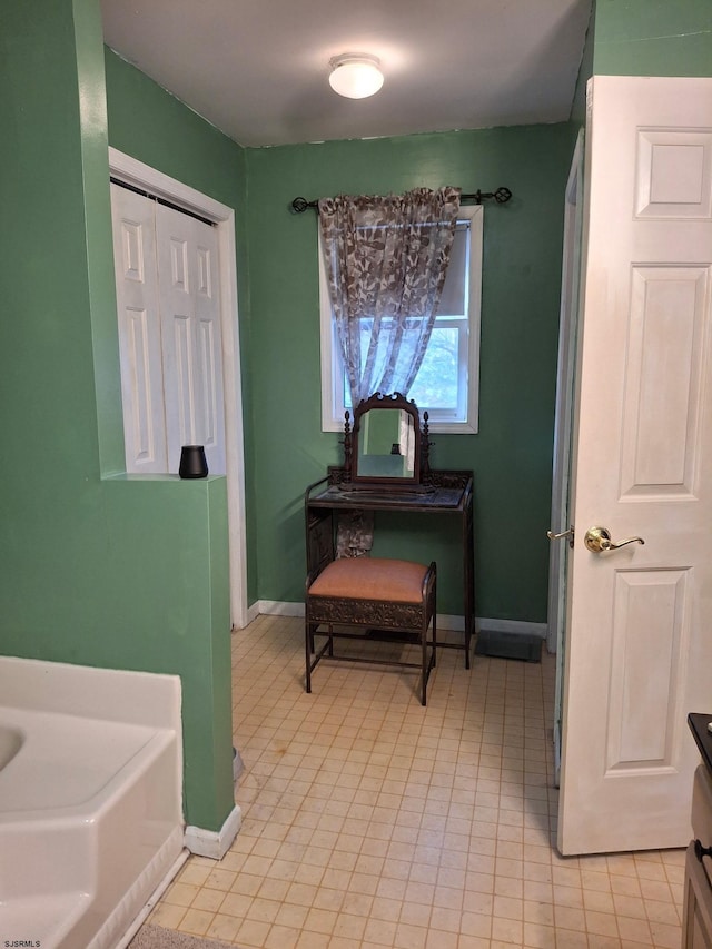 bathroom with vanity and a tub to relax in