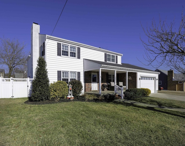 view of front of house featuring a porch, a garage, and a front lawn