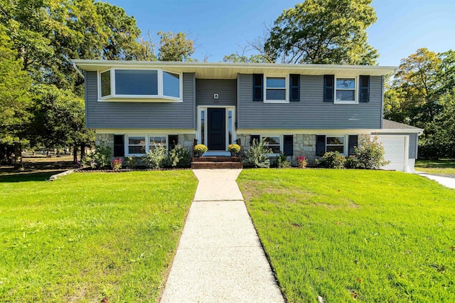 split foyer home with a garage and a front lawn