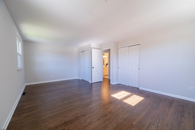 spare room with dark hardwood / wood-style floors