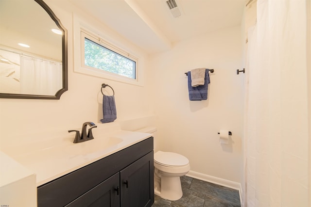 bathroom featuring vanity and toilet