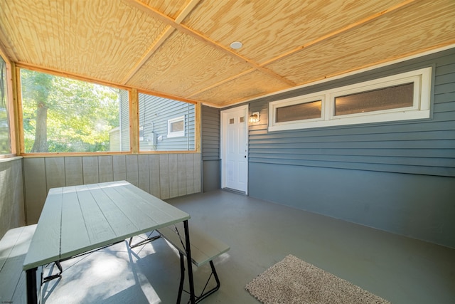 unfurnished sunroom featuring wooden ceiling