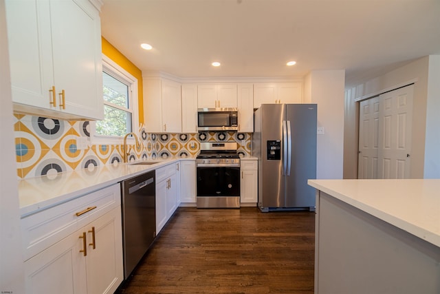 kitchen with sink, white cabinets, and appliances with stainless steel finishes