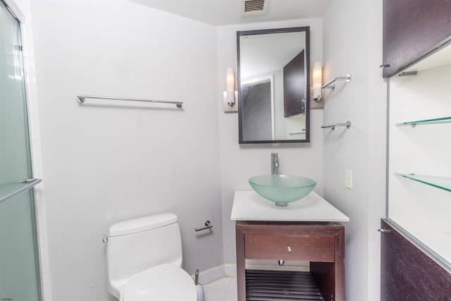 bathroom with vanity, tile patterned floors, toilet, and walk in shower