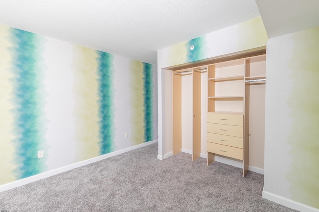 unfurnished bedroom featuring carpet flooring and a textured ceiling