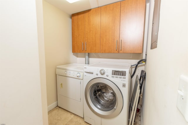 washroom featuring washing machine and dryer and cabinets