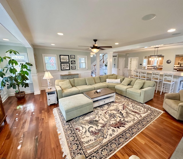 living room with crown molding, ceiling fan, and wood-type flooring