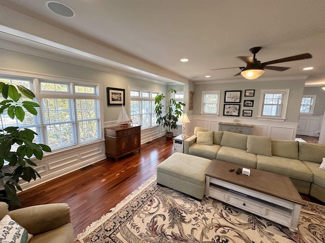 living room featuring hardwood / wood-style floors, crown molding, and ceiling fan