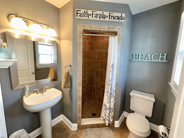 bathroom featuring tile patterned flooring, toilet, sink, and a shower with shower curtain