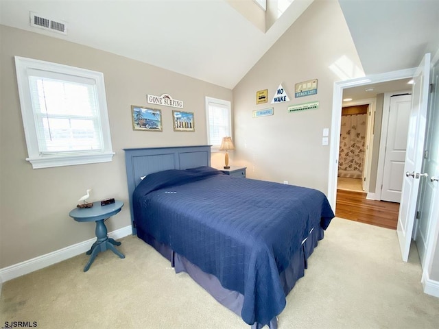 carpeted bedroom featuring vaulted ceiling