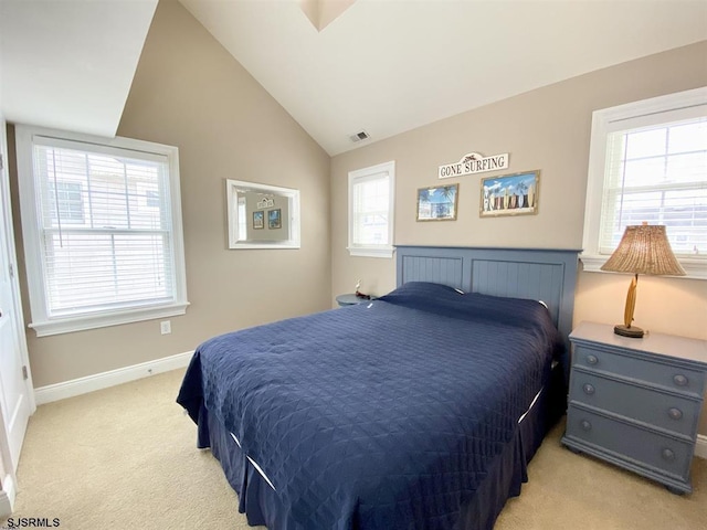 bedroom with vaulted ceiling and light colored carpet