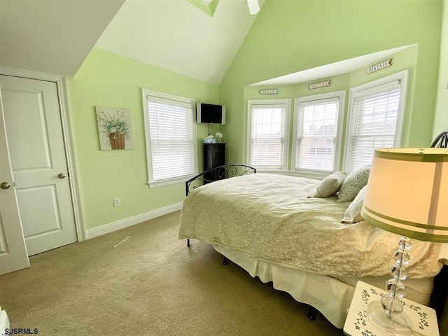 bedroom featuring lofted ceiling and light carpet