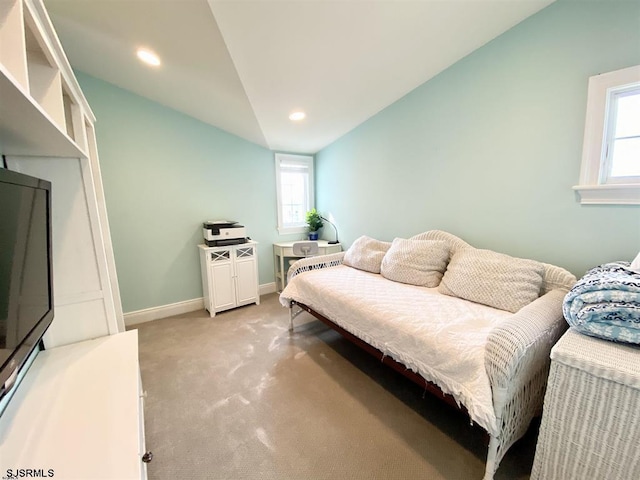 bedroom featuring vaulted ceiling and light colored carpet