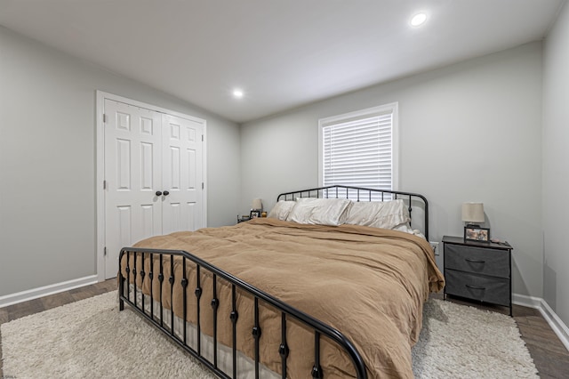 bedroom with hardwood / wood-style floors and a closet