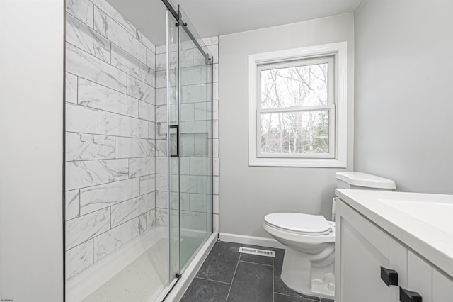 bathroom with walk in shower, vanity, toilet, and tile patterned flooring