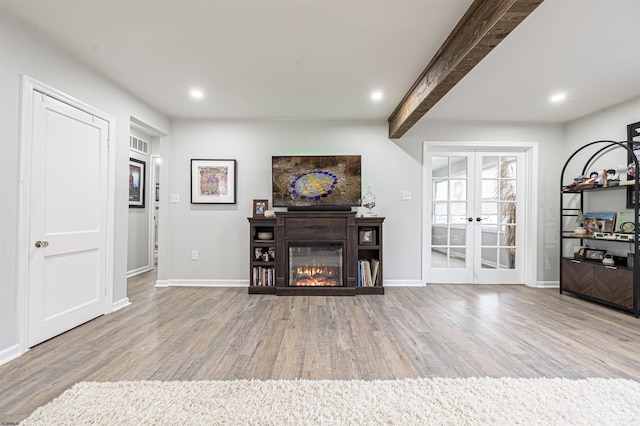 living room featuring hardwood / wood-style flooring, beamed ceiling, and french doors