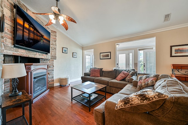 living room with lofted ceiling, crown molding, dark hardwood / wood-style floors, and ceiling fan