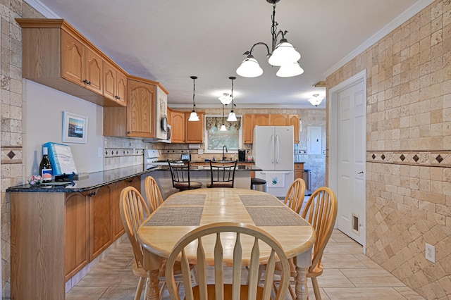 tiled dining space with crown molding and sink