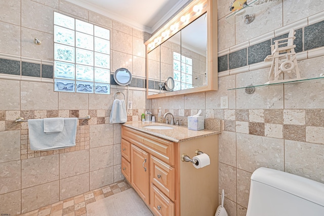 bathroom featuring ornamental molding, toilet, tile walls, and vanity