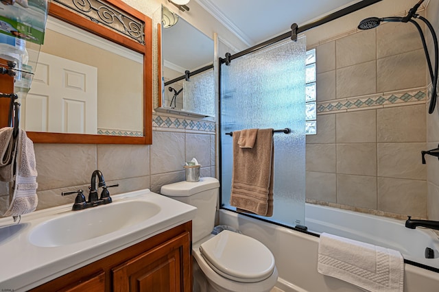 full bathroom featuring tile walls, enclosed tub / shower combo, vanity, toilet, and crown molding