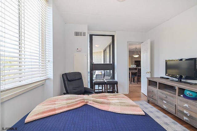 bedroom with hardwood / wood-style flooring