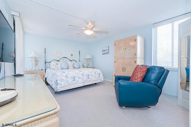 bedroom with ceiling fan and carpet