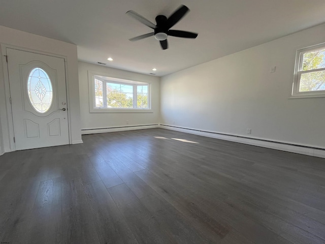 foyer entrance featuring baseboard heating, ceiling fan, and dark hardwood / wood-style floors