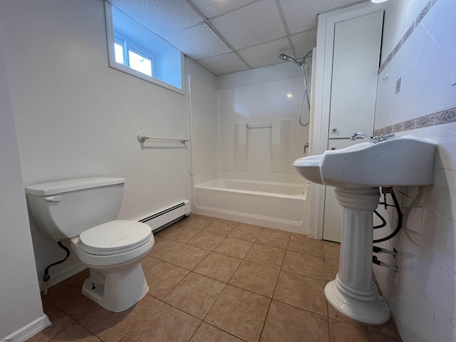 bathroom featuring toilet, a paneled ceiling, a baseboard radiator, shower / washtub combination, and tile patterned flooring