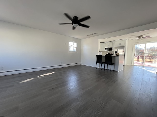 unfurnished living room featuring dark hardwood / wood-style flooring, ceiling fan, and baseboard heating