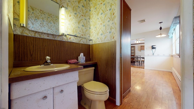 bathroom featuring vanity, toilet, and hardwood / wood-style floors