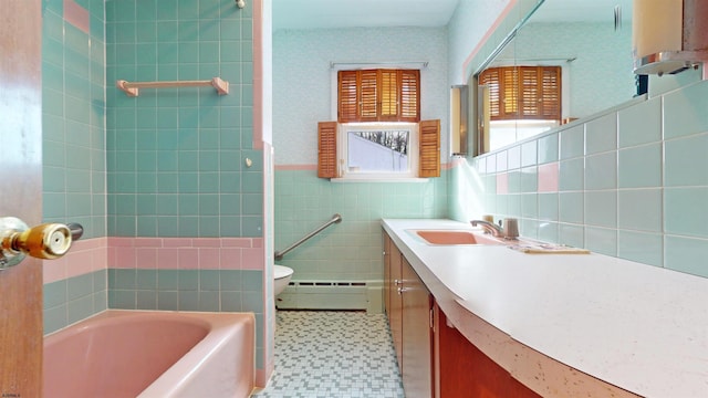 bathroom featuring toilet, tile walls, a baseboard radiator, vanity, and a bathtub