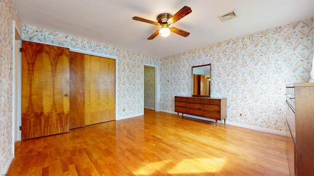 unfurnished bedroom with ceiling fan and light wood-type flooring