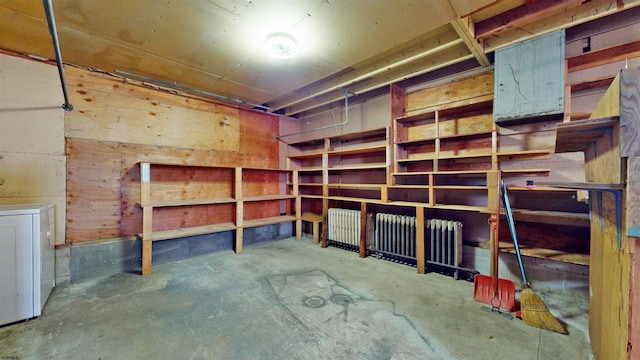 storage room featuring radiator and washer / dryer