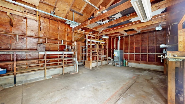 interior space with concrete flooring and water heater