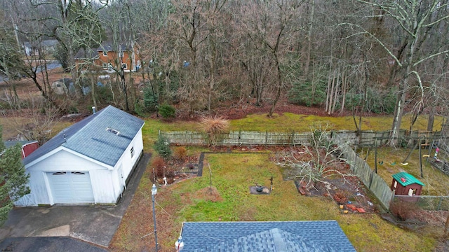 view of yard with a garage and an outbuilding