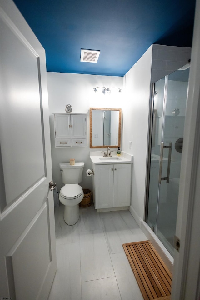 bathroom with vanity, an enclosed shower, and toilet