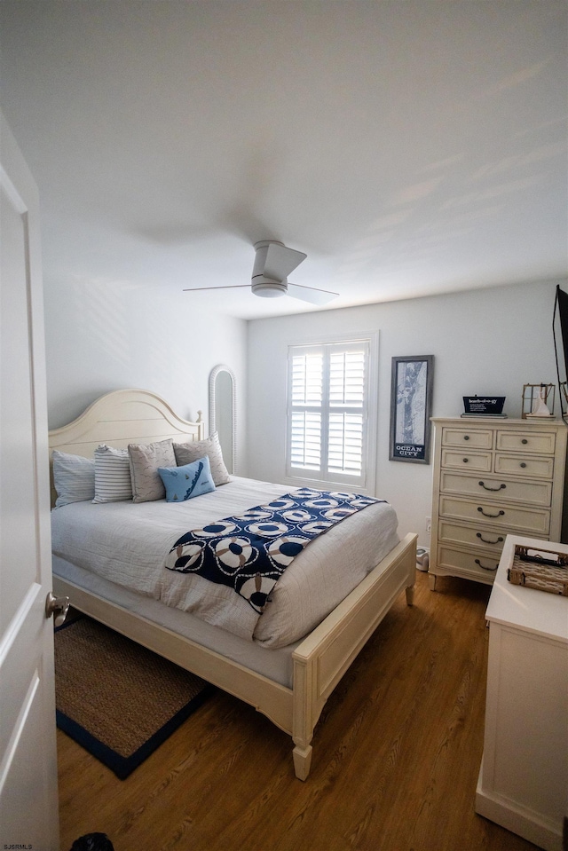 bedroom featuring dark hardwood / wood-style flooring and ceiling fan