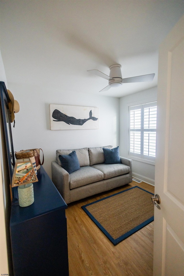 living room with hardwood / wood-style floors and ceiling fan