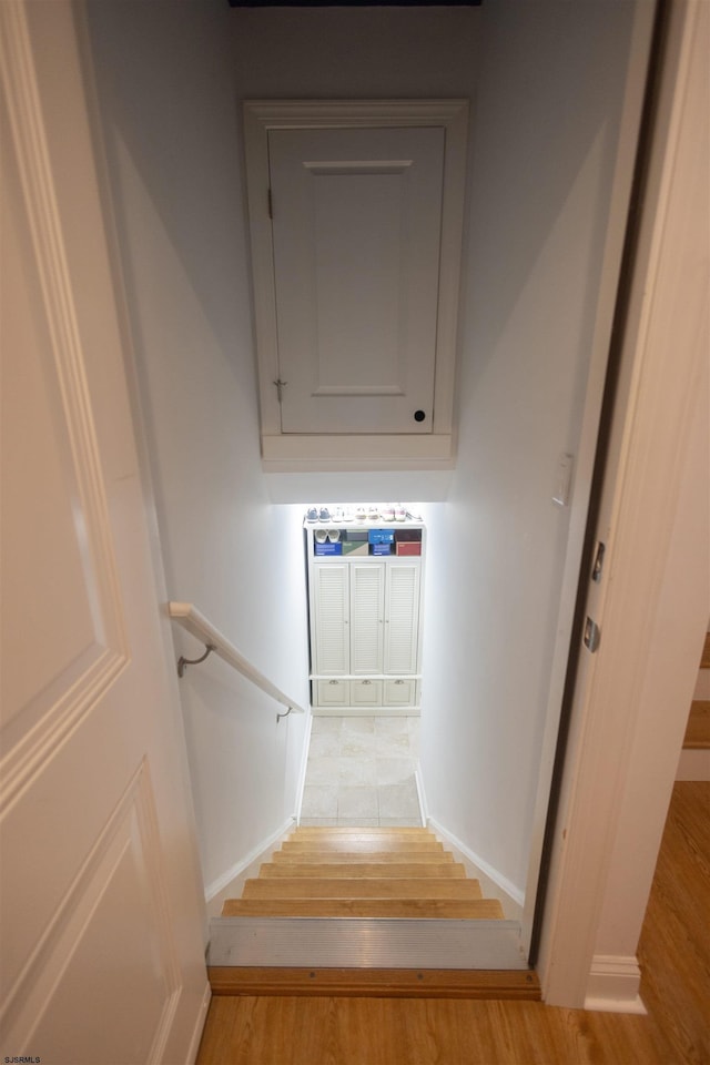 staircase with hardwood / wood-style floors