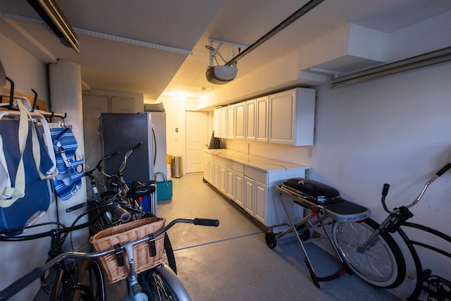 garage featuring a garage door opener and stainless steel fridge