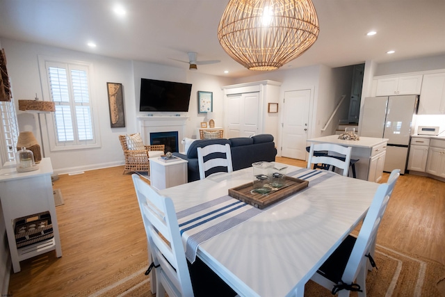 dining area featuring ceiling fan and light wood-type flooring