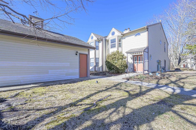 view of side of property with a yard