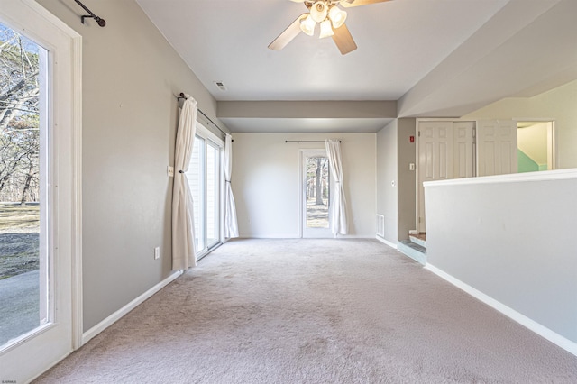 carpeted spare room with ceiling fan