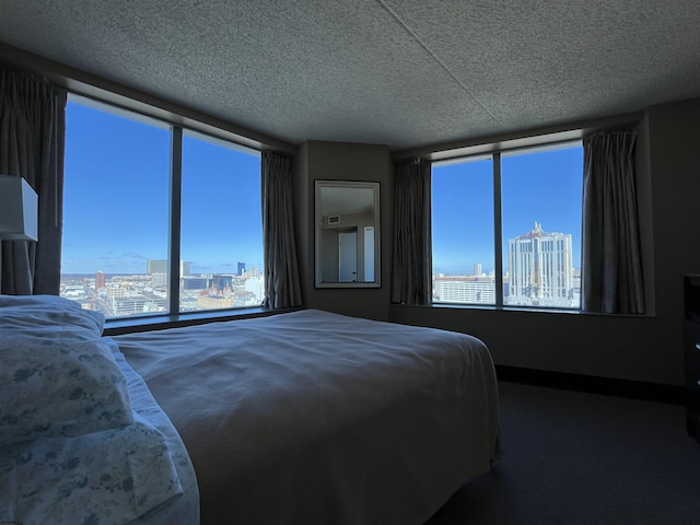 carpeted bedroom featuring a textured ceiling