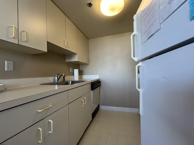 kitchen with sink, dishwasher, white refrigerator, white cabinets, and light tile patterned flooring