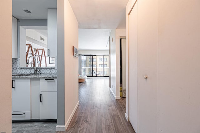 hall featuring sink and hardwood / wood-style floors