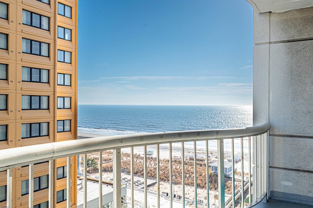 balcony featuring a water view and a beach view