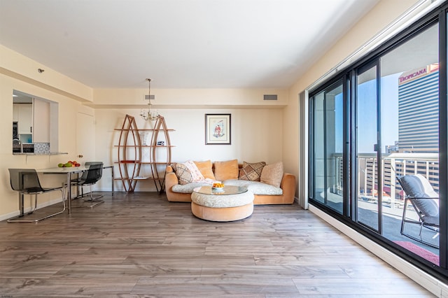 sitting room with hardwood / wood-style flooring and a notable chandelier