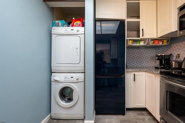 washroom with stacked washer / drying machine